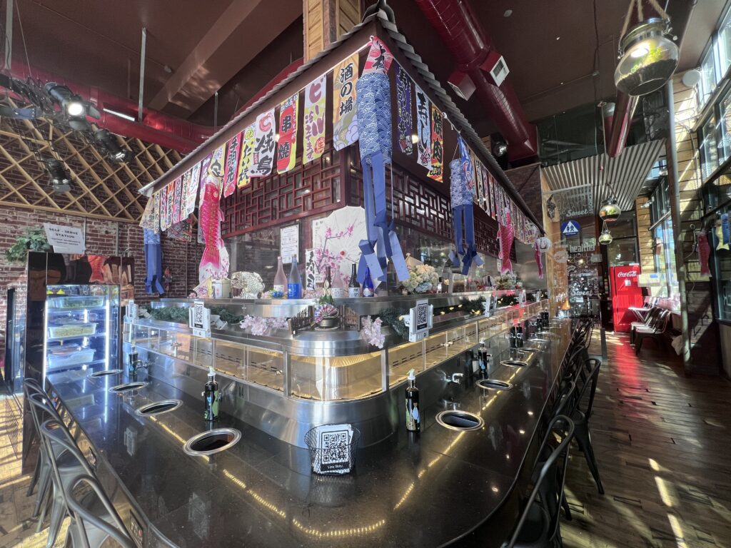 The glass-lined dining room at Chubby Cattle Hot Pot on Broadway
