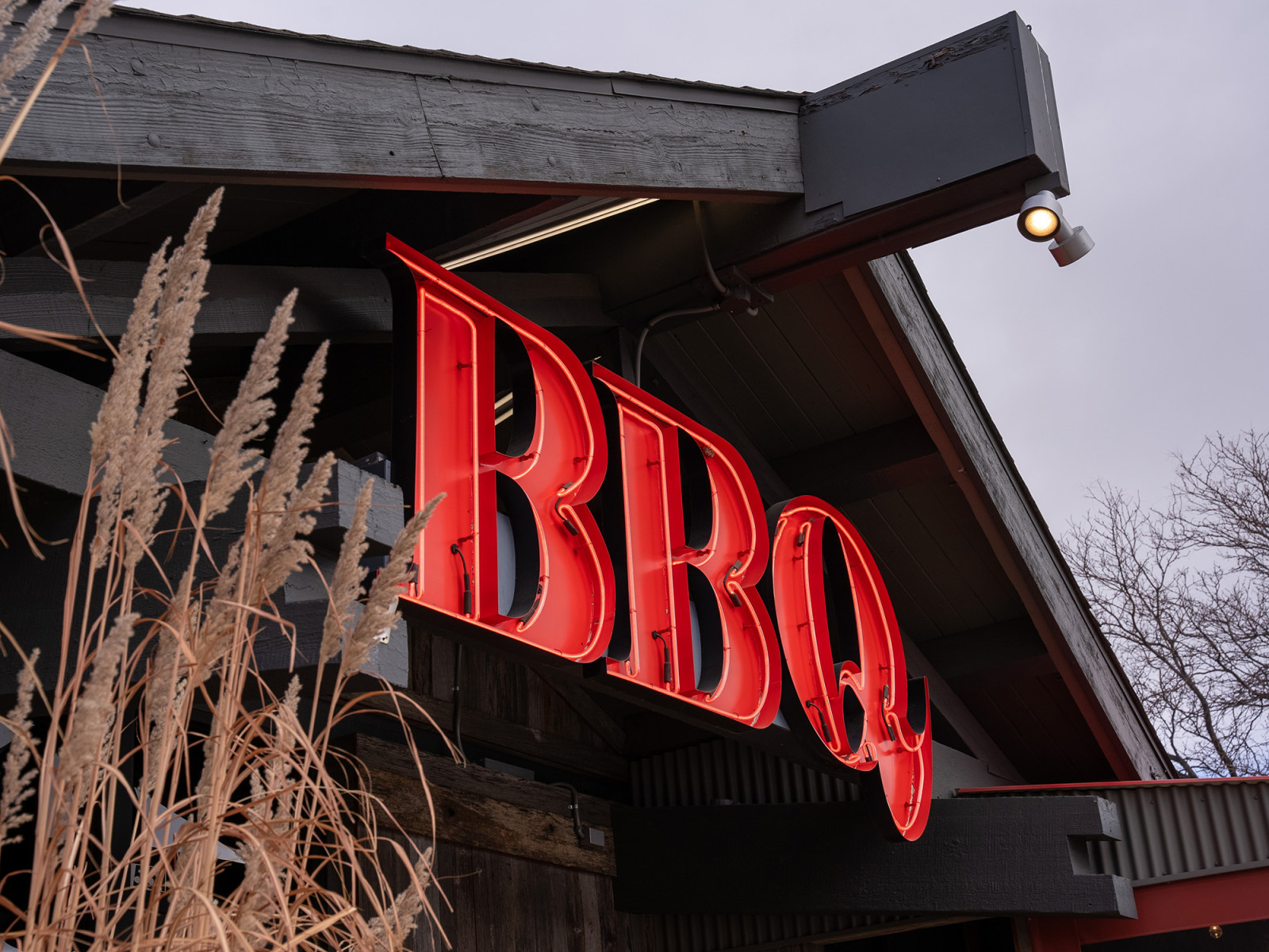 The illuminated BBQ sign at Smokin’ Dave’s Denver near Pecos